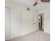 This carpeted bedroom features a closet with sliding doors and a ceiling fan for added comfort at 3718 E Sheridan St, Phoenix, AZ 85008