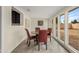 Bright dining area with backyard views and a round table with red chairs at 3718 E Sheridan St, Phoenix, AZ 85008