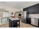 This bright kitchen features stainless steel appliances, a center island, and black lower cabinets at 3718 E Sheridan St, Phoenix, AZ 85008