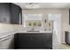 This modern kitchen features sleek dark cabinets, marble countertops, and stainless steel appliances at 3718 E Sheridan St, Phoenix, AZ 85008