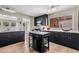 Modern kitchen featuring black cabinets, white countertops, and stainless steel appliances at 3718 E Sheridan St, Phoenix, AZ 85008