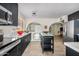 Modern kitchen featuring stainless steel appliances, a center island, and contrasting dark cabinetry at 3718 E Sheridan St, Phoenix, AZ 85008