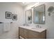 Bright bathroom featuring a double sink vanity with a towel bar and wall mounted mirrors at 37206 N Tom Darlington Dr # 13, Carefree, AZ 85377