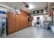 Organized garage space featuring built-in storage cabinets and epoxy flooring at 37206 N Tom Darlington Dr # 13, Carefree, AZ 85377