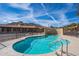 Community pool with clear blue water, desert landscaping, mountain views, and sunny skies at 37206 N Tom Darlington Dr # 13, Carefree, AZ 85377