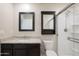 Bathroom featuring granite countertops, dark wood cabinetry, and a shower at 3911 S 79Th Ln, Phoenix, AZ 85043