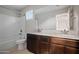 Bathroom features a double sink vanity with granite countertop, framed mirror, and a shower over tub at 3911 S 79Th Ln, Phoenix, AZ 85043