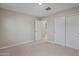 Bedroom with neutral walls and carpet, closet, and paneled door at 3911 S 79Th Ln, Phoenix, AZ 85043