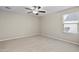 Bedroom featuring neutral carpet flooring, a ceiling fan, and bright window at 3911 S 79Th Ln, Phoenix, AZ 85043