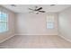 Spacious bedroom with a ceiling fan, tile flooring, and bright windows at 3911 S 79Th Ln, Phoenix, AZ 85043