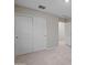 This bedroom features neutral carpeting, paint and large closet doors at 3911 S 79Th Ln, Phoenix, AZ 85043