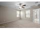 Bedroom featuring neutral carpet flooring, a ceiling fan, and bright windows at 3911 S 79Th Ln, Phoenix, AZ 85043