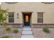 Charming front entrance featuring a black door, stone accents, and manicured landscaping at 3911 S 79Th Ln, Phoenix, AZ 85043