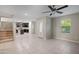 Open living area with tile flooring, ceiling fan, and a view into the kitchen at 3911 S 79Th Ln, Phoenix, AZ 85043