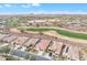 Scenic aerial view of a desert homesite with a lush green golf course nearby with mountain views at 3956 N San Marin Dr, Florence, AZ 85132