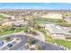 An aerial view showcases the expansive golf course, clubhouse, and parking area in a desert landscape at 3956 N San Marin Dr, Florence, AZ 85132