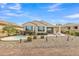 A private backyard oasis featuring a pebble landscape, spa, covered patio, and desert plants at 3956 N San Marin Dr, Florence, AZ 85132