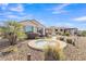 Private backyard oasis featuring a pebble landscape, spa, covered patio, and desert plants at 3956 N San Marin Dr, Florence, AZ 85132