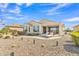 Relaxing backyard with a covered patio, desert landscaping, and lounge seating at 3956 N San Marin Dr, Florence, AZ 85132