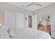 Bright bedroom featuring a ceiling fan, dresser, and a closet with sliding doors at 3956 N San Marin Dr, Florence, AZ 85132