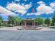 Inviting Union Center clubhouse with American flag, colorful landscaping, and brick facade on a sunny day at 3956 N San Marin Dr, Florence, AZ 85132