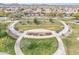 Aerial view of a beautifully landscaped community park with walking paths and green spaces at 3956 N San Marin Dr, Florence, AZ 85132