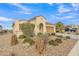 Charming home with a tile roof, arched entryway and desert landscaping for low maintenance and vibrant color at 3956 N San Marin Dr, Florence, AZ 85132