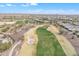 Aerial view of lush golf course in desert community surrounded by houses on a clear, sunny day with mountains in distance at 3956 N San Marin Dr, Florence, AZ 85132