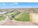 Expansive aerial perspective featuring a golf course with a line of golf carts ready for play at 3956 N San Marin Dr, Florence, AZ 85132