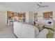 Open-concept living room with view into the kitchen and bright neutral color palette at 3956 N San Marin Dr, Florence, AZ 85132