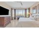 Main bedroom with a ceiling fan, large window, and neutral wall paint at 3956 N San Marin Dr, Florence, AZ 85132