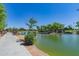 Community pond with walking path and bridge offers a scenic view for residents, promoting relaxation and outdoor enjoyment at 3956 N San Marin Dr, Florence, AZ 85132