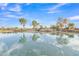 Picturesque pond featuring a quaint walking bridge and lush greenery at 3956 N San Marin Dr, Florence, AZ 85132