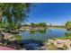 Tranquil pond features a rock waterfall and a stage area, creating a relaxing place for community residents to gather at 3956 N San Marin Dr, Florence, AZ 85132