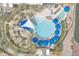 Birds-eye view of a large, luxurious pool area with umbrellas, sunbeds, and a wading pool at 3956 N San Marin Dr, Florence, AZ 85132