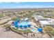 Overhead view of a resort-style pool with blue umbrellas and lush landscaping in a residential community at 3956 N San Marin Dr, Florence, AZ 85132