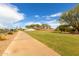 Inviting entrance to the Anthem community with lush landscaping and a wide sidewalk at 4107 N Hawthorn Dr, Florence, AZ 85132