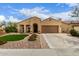 Charming single-story home featuring desert landscaping, a two-car garage, and an inviting front entry with an arched doorway at 4107 N Hawthorn Dr, Florence, AZ 85132