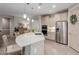 Modern kitchen featuring quartz countertops, stainless steel appliances, and seating around the large island at 4107 N Hawthorn Dr, Florence, AZ 85132