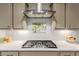 A modern kitchen features stainless steel appliances, white subway tile backsplash, and light gray cabinetry at 4107 N Hawthorn Dr, Florence, AZ 85132