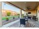 A covered patio with an outdoor seating area, ceiling fan, and an outdoor area with grass at 4107 N Hawthorn Dr, Florence, AZ 85132