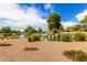 Scenic pond view with rock waterfall and surrounding landscaping at 4107 N Hawthorn Dr, Florence, AZ 85132