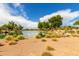 Relaxing view of the community pond and water feature amidst lush desert landscaping at 4107 N Hawthorn Dr, Florence, AZ 85132