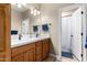 Well-lit bathroom featuring a double sink vanity, light fixtures, and a shower at 4217 E Edgemont Ave, Phoenix, AZ 85008