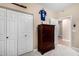 A bedroom featuring a large closet, dark wood dresser, and a sports-themed decor at 4217 E Edgemont Ave, Phoenix, AZ 85008