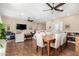 Open-concept dining area with a large wooden table, seating for eight, and ceiling fans at 4217 E Edgemont Ave, Phoenix, AZ 85008