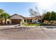 Charming single-story home with stucco siding, lush landscaping, and a two-car garage at 4217 E Edgemont Ave, Phoenix, AZ 85008