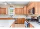 Charming kitchen featuring stainless steel appliances, quartz countertops, gas range and decorative lighting at 4217 E Edgemont Ave, Phoenix, AZ 85008