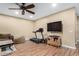 Well-lit Gathering room featuring hardwood floors, a sofa, and a treadmill for exercise at 4217 E Edgemont Ave, Phoenix, AZ 85008