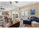 Open concept living space featuring fireplace, seating, and view to the kitchen at 4217 E Edgemont Ave, Phoenix, AZ 85008